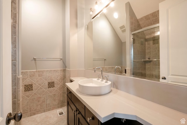 2227 E 5340 S, Holladay, UT 84117 - bathroom featuring visible vents, a tile shower, tile walls, tile patterned flooring, and vanity