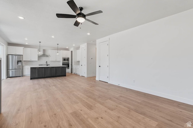 1203 Crest Dale Ln, Santaquin, UT 84655 - unfurnished living room with light wood-style flooring, baseboards, recessed lighting, a ceiling fan, and a sink