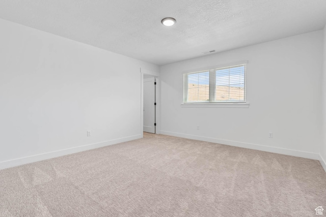 1203 Crest Dale Ln, Santaquin, UT 84655 - spare room featuring light carpet, baseboards, visible vents, and a textured ceiling