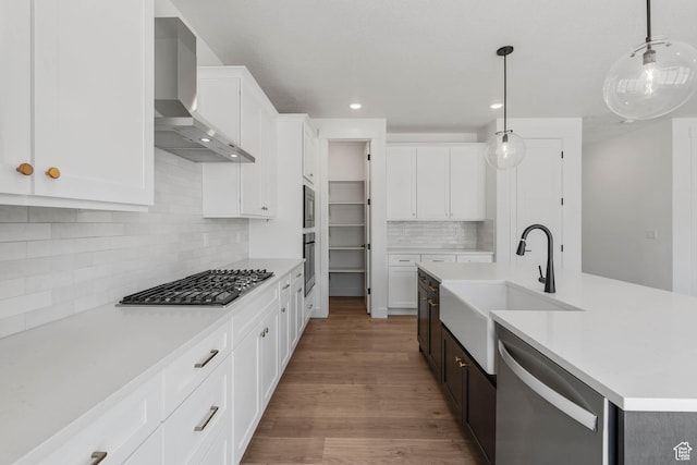 1203 Crest Dale Ln, Santaquin, UT 84655 - kitchen with a sink, light countertops, wall chimney range hood, and stainless steel appliances