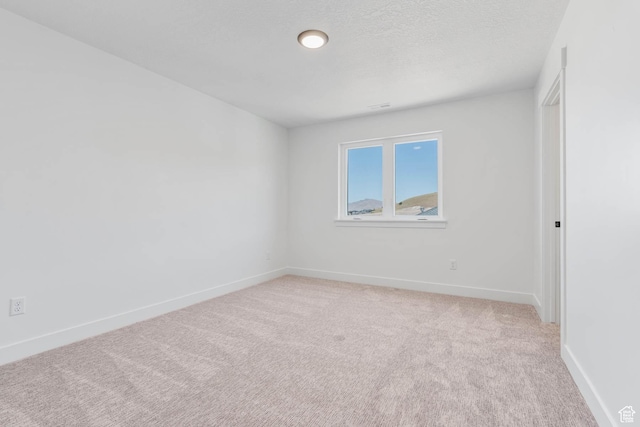 1203 Crest Dale Ln, Santaquin, UT 84655 - unfurnished room featuring visible vents, light carpet, baseboards, and a textured ceiling
