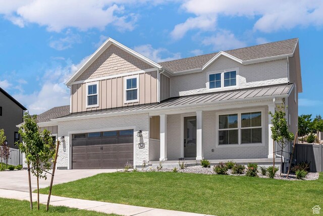 1203 Crest Dale Ln, Santaquin, UT 84655 - view of front of house with driveway, covered porch, a standing seam roof, an attached garage, and brick siding