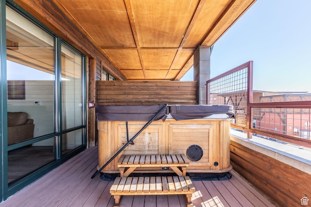 wooden deck with a hot tub