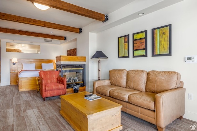 living room featuring beam ceiling and a multi sided fireplace