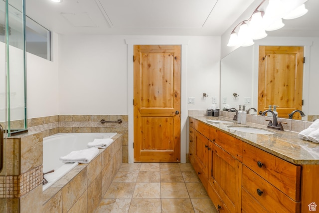 bathroom with vanity, tile flooring, and tiled tub