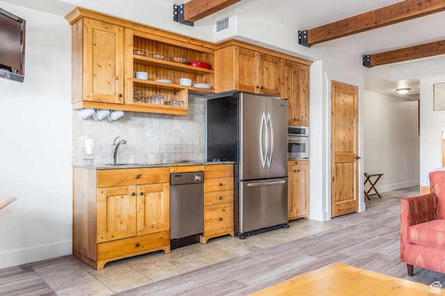 kitchen with appliances with stainless steel finishes, beamed ceiling, backsplash, sink, and light stone countertops