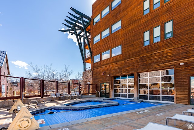 view of pool with a community hot tub