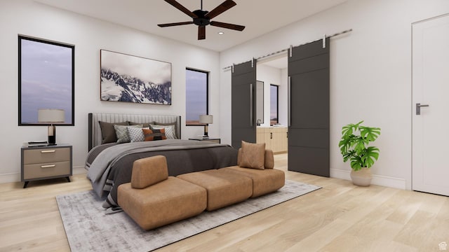 2235 Salida Del Sol, Moab, UT 84532 - bedroom featuring light wood-type flooring, recessed lighting, a barn door, connected bathroom, and a ceiling fan