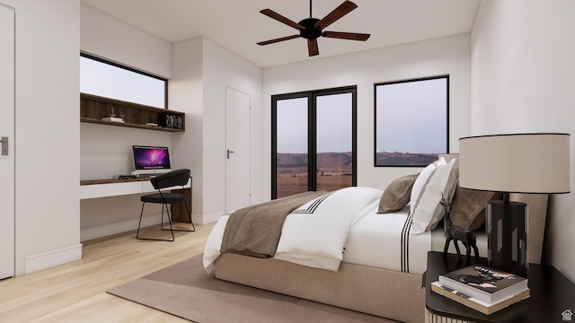 2235 Salida Del Sol, Moab, UT 84532 - bedroom with wood finished floors, built in desk, access to exterior, and ceiling fan