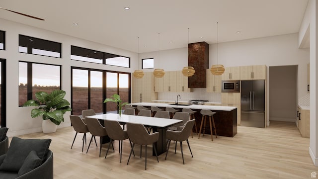 2235 Salida Del Sol, Moab, UT 84532 - dining room featuring a towering ceiling, light wood-type flooring, and recessed lighting