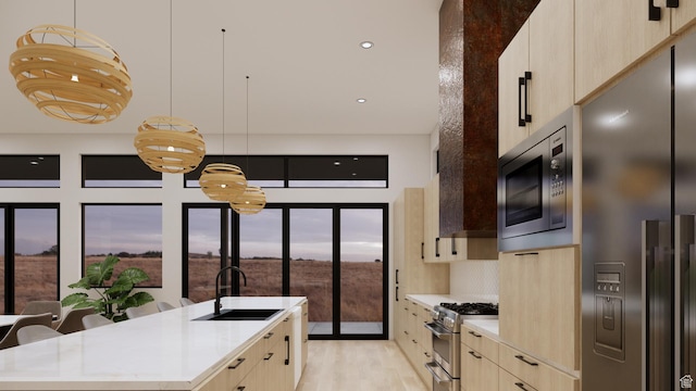 2235 Salida Del Sol, Moab, UT 84532 - kitchen with appliances with stainless steel finishes, modern cabinets, light brown cabinetry, light countertops, and a kitchen island with sink