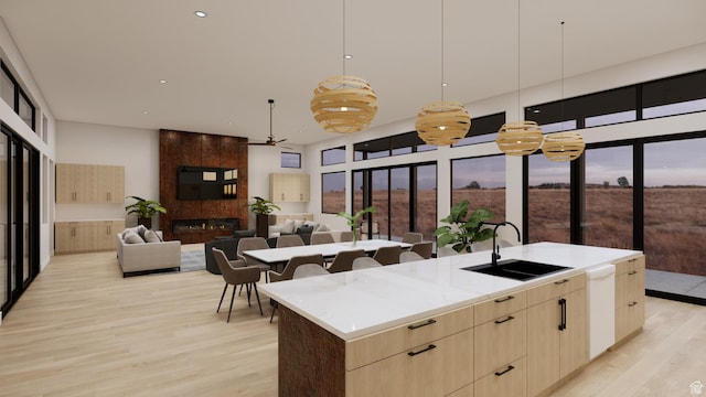 2235 Salida Del Sol, Moab, UT 84532 - kitchen featuring light brown cabinets, a ceiling fan, light wood-type flooring, modern cabinets, and a large island with sink