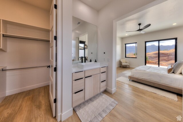2194 Salida Del Sol, Moab, UT 84532 - ensuite bathroom featuring baseboards, a ceiling fan, ensuite bath, wood finished floors, and vanity