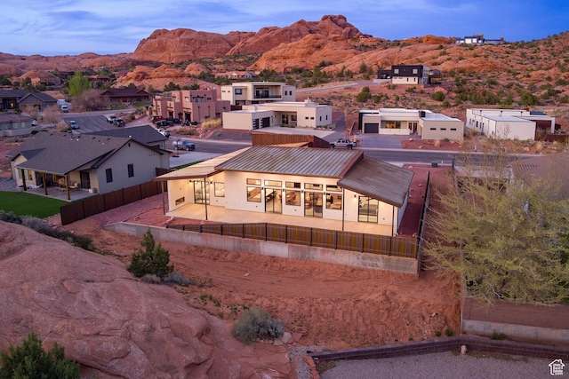 2194 Salida Del Sol, Moab, UT 84532 - back of property featuring a fenced backyard, a patio area, metal roof, a mountain view, and a residential view