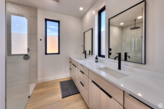 2194 Salida Del Sol, Moab, UT 84532 - full bath featuring a tile shower, wood finished floors, double vanity, and a sink