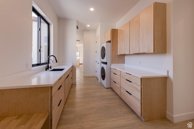 2194 Salida Del Sol, Moab, UT 84532 - kitchen with stacked washer / dryer, a sink, light brown cabinetry, and modern cabinets
