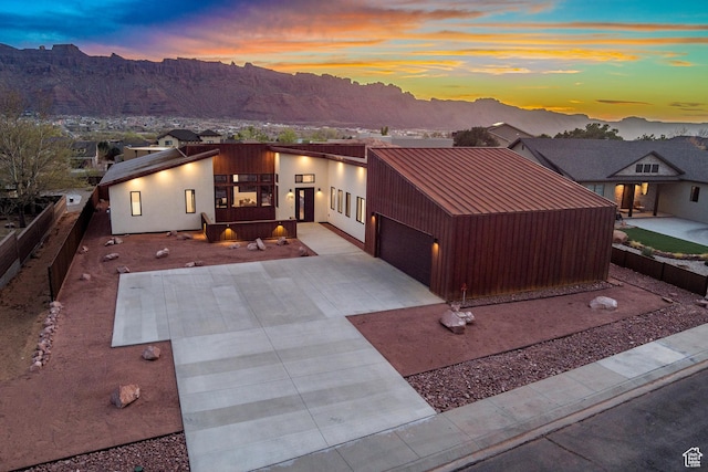 2194 Salida Del Sol, Moab, UT 84532 - contemporary home with a mountain view, a patio area, a garage, fence, and driveway