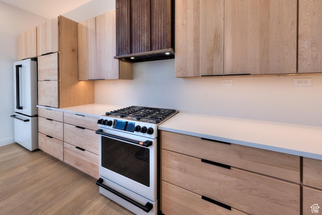 2194 Salida Del Sol, Moab, UT 84532 - kitchen with modern cabinets, white gas range, light wood-type flooring, light countertops, and light brown cabinets