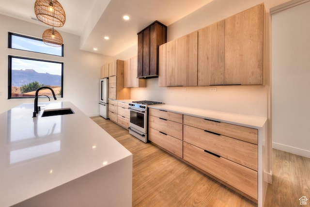 2194 Salida Del Sol, Moab, UT 84532 - kitchen with light wood-type flooring, light brown cabinets, light countertops, stainless steel appliances, and a sink