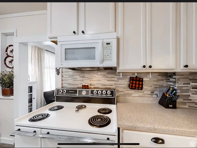 27 W 150 S, Garden City, UT 84028 - kitchen with stove, tasteful backsplash, and white cabinetry