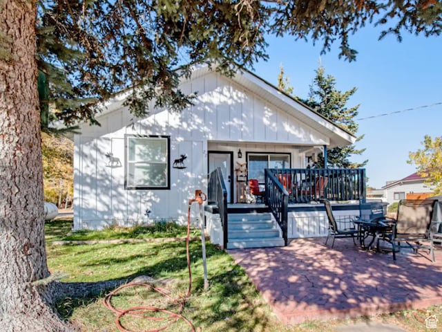 27 W 150 S, Garden City, UT 84028 - rear view of house with a wooden deck, a patio area, french doors, and a lawn