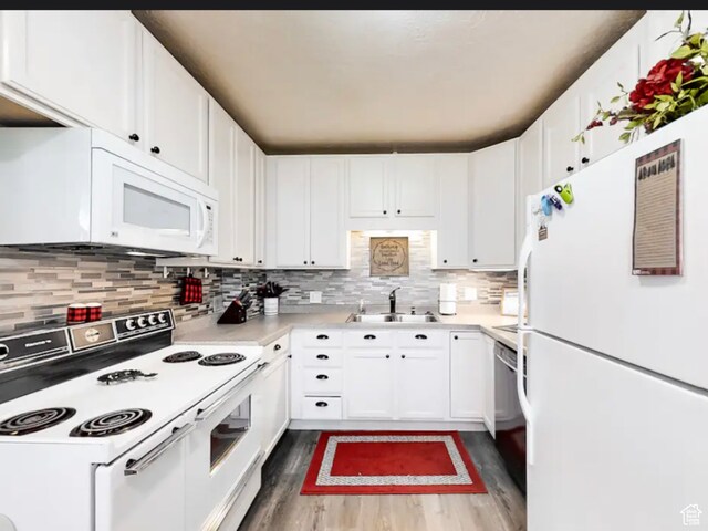 27 W 150 S, Garden City, UT 84028 - kitchen featuring tasteful backsplash, white appliances, sink, white cabinetry, and hardwood / wood-style flooring