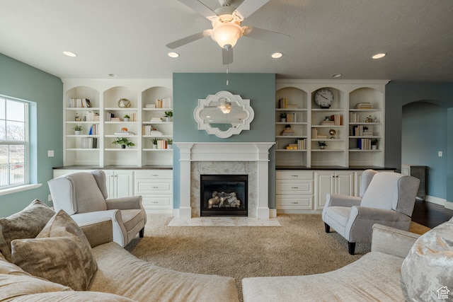 340 E Maple St, Mapleton, UT 84664 - living room featuring a tiled fireplace, ceiling fan, light colored carpet, and a textured ceiling