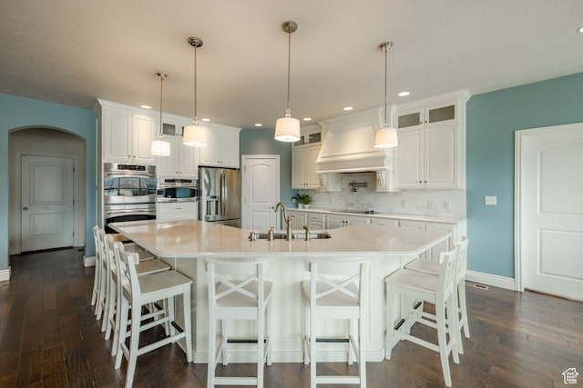 340 E Maple St, Mapleton, UT 84664 - kitchen featuring appliances with stainless steel finishes, custom exhaust hood, sink, decorative light fixtures, and white cabinets