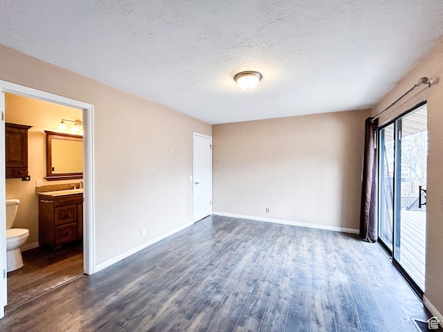 764 W 1275 N, Farmington, UT 84025 - unfurnished bedroom featuring a textured ceiling, ensuite bathroom, dark wood-type flooring, and sink