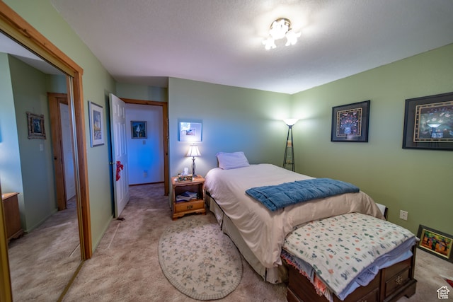 bedroom featuring light carpet