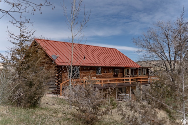 back of house with a wooden deck