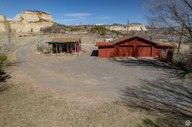 exterior space with a garage and a mountain view