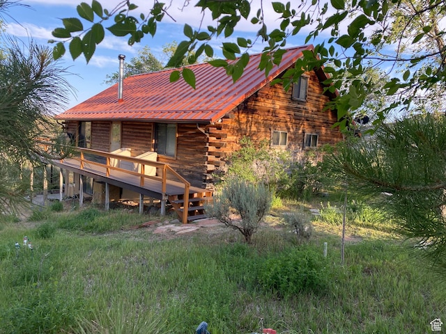 back of property featuring a wooden deck