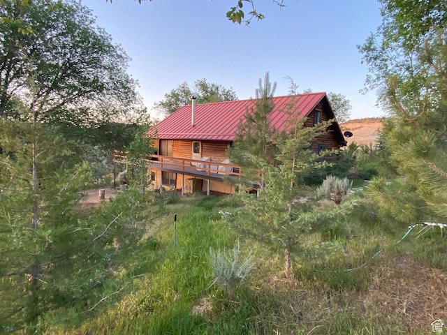 back of property featuring a wooden deck