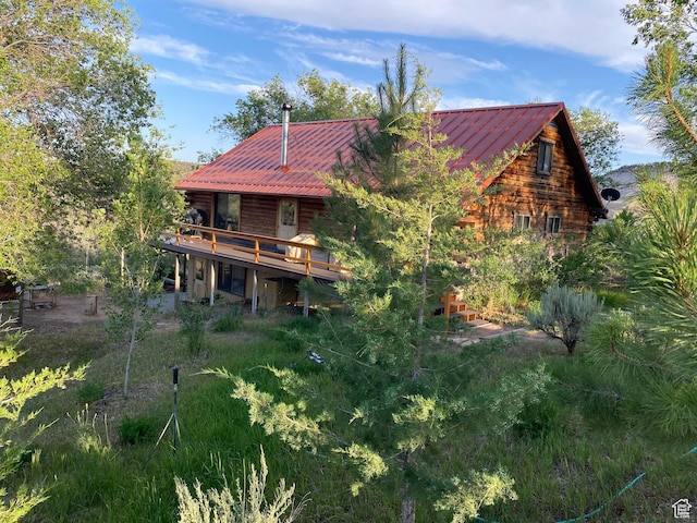back of property featuring a deck