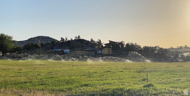 view of yard featuring a mountain view and a rural view