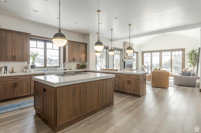 1905 E Kings Peak Cir, Heber City, UT 84032 - kitchen featuring open floor plan, light countertops, stainless steel gas stovetop, and a center island