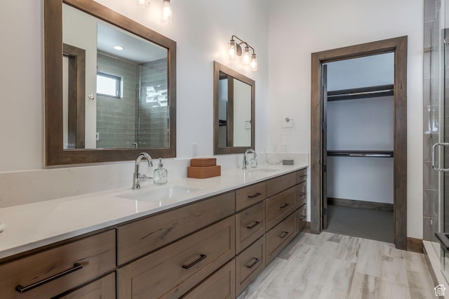 1905 E Kings Peak Cir, Heber City, UT 84032 - bathroom with double vanity, a shower stall, a spacious closet, and a sink