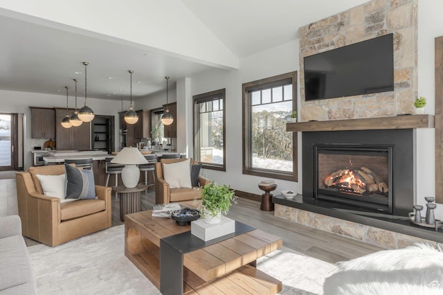 1905 E Kings Peak Cir, Heber City, UT 84032 - living area with lofted ceiling, a fireplace, and light wood-style flooring