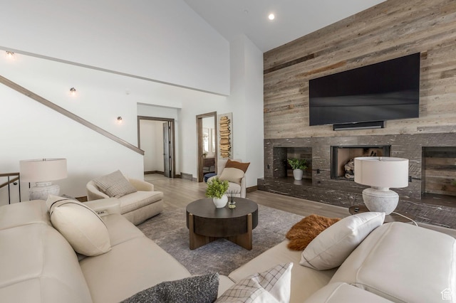 1905 E Kings Peak Cir, Heber City, UT 84032 - living room with a fireplace, wooden walls, a high ceiling, and wood finished floors