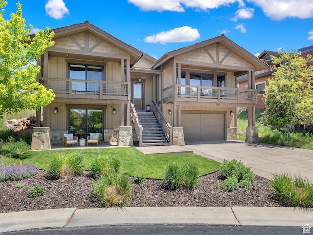 1707 E Kings Peak Cir N, Heber City, UT 84032 - view of front of home with stone siding, a garage, concrete driveway, and a balcony