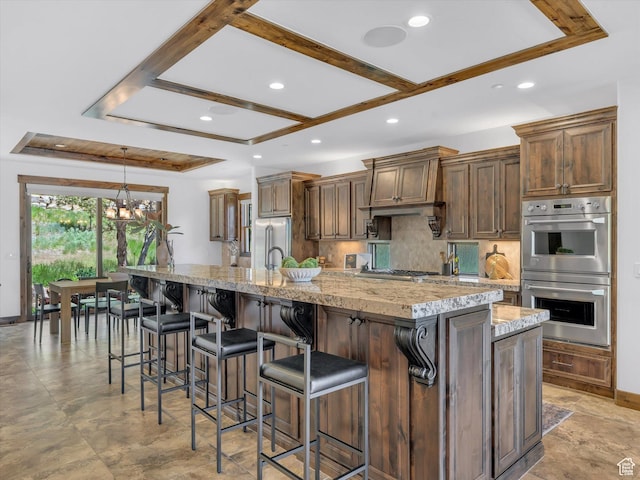1707 E Kings Peak Cir N, Heber City, UT 84032 - kitchen with appliances with stainless steel finishes, recessed lighting, a large island with sink, a chandelier, and backsplash