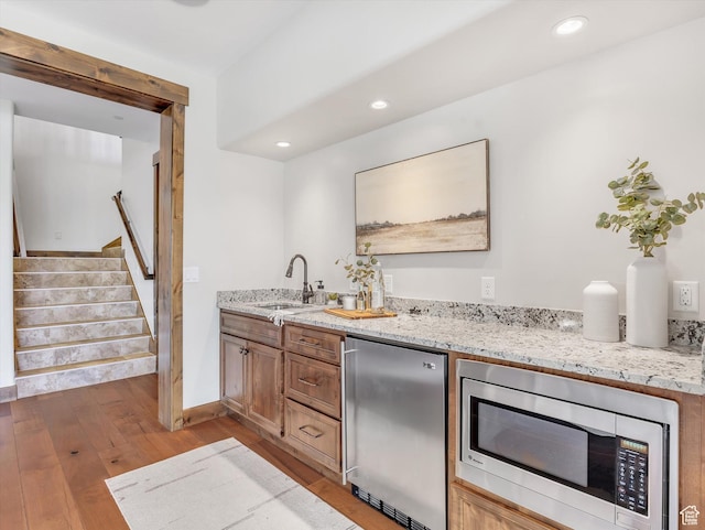 1707 E Kings Peak Cir N, Heber City, UT 84032 - indoor wet bar with stainless steel microwave, refrigerator, light wood finished floors, stairway, and recessed lighting
