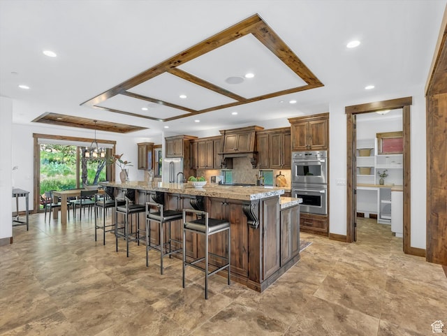 1707 E Kings Peak Cir N, Heber City, UT 84032 - kitchen featuring double oven, recessed lighting, a chandelier, a large island, and a breakfast bar area