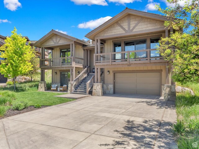 1707 E Kings Peak Cir N, Heber City, UT 84032 - view of front of home with stone siding, an attached garage, stairs, and driveway
