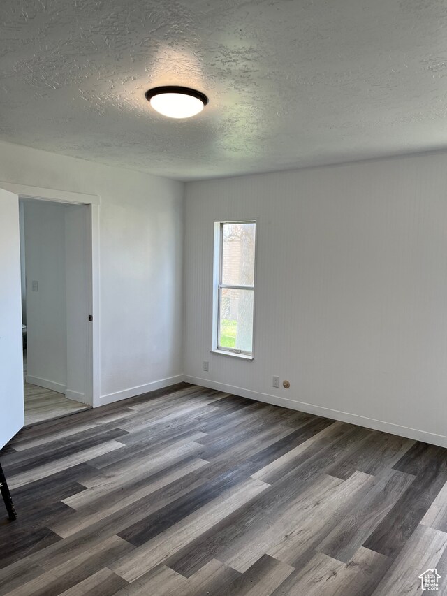 55 E 200 S, Ephraim, UT 84627 - empty room featuring a textured ceiling and dark wood-type flooring