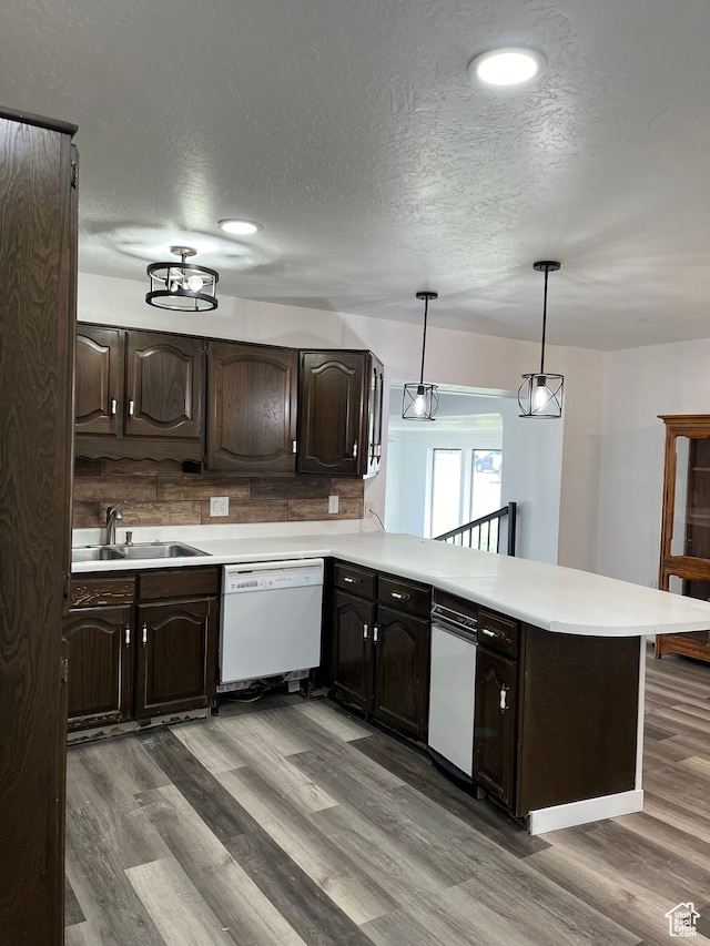 55 E 200 S, Ephraim, UT 84627 - kitchen featuring hanging light fixtures, light hardwood / wood-style flooring, dark brown cabinets, white dishwasher, and sink