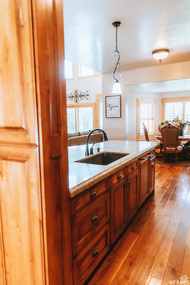 493 N 12500 W, Bluebell, UT 84007 - kitchen featuring sink, light stone countertops, hardwood / wood-style flooring, and decorative light fixtures