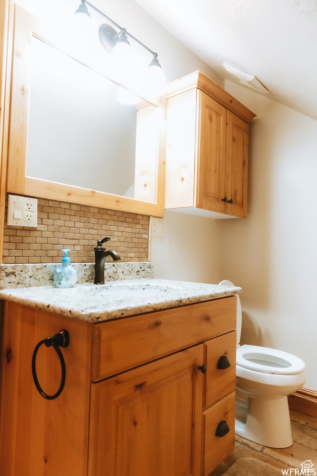 493 N 12500 W, Bluebell, UT 84007 - bathroom featuring backsplash, vanity, toilet, and hardwood / wood-style flooring
