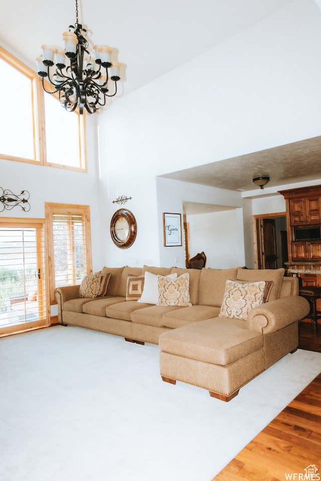 493 N 12500 W, Bluebell, UT 84007 - living room featuring wood-type flooring, a high ceiling, and an inviting chandelier
